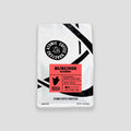 Coffee package labeled 'Burundi Bahire' by Atomic Coffee Roasters on a gray background