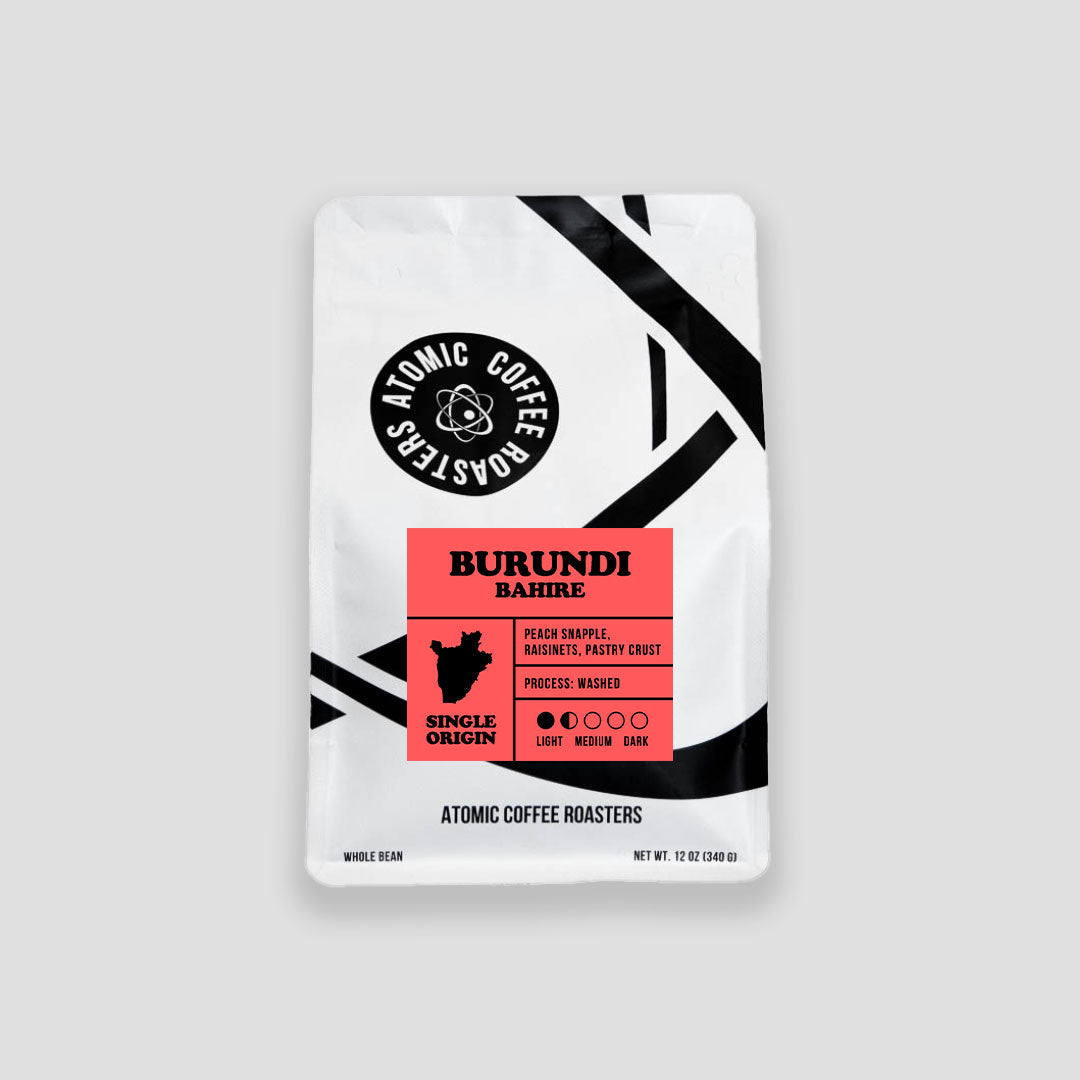Coffee package labeled 'Burundi Bahire' by Atomic Coffee Roasters on a gray background