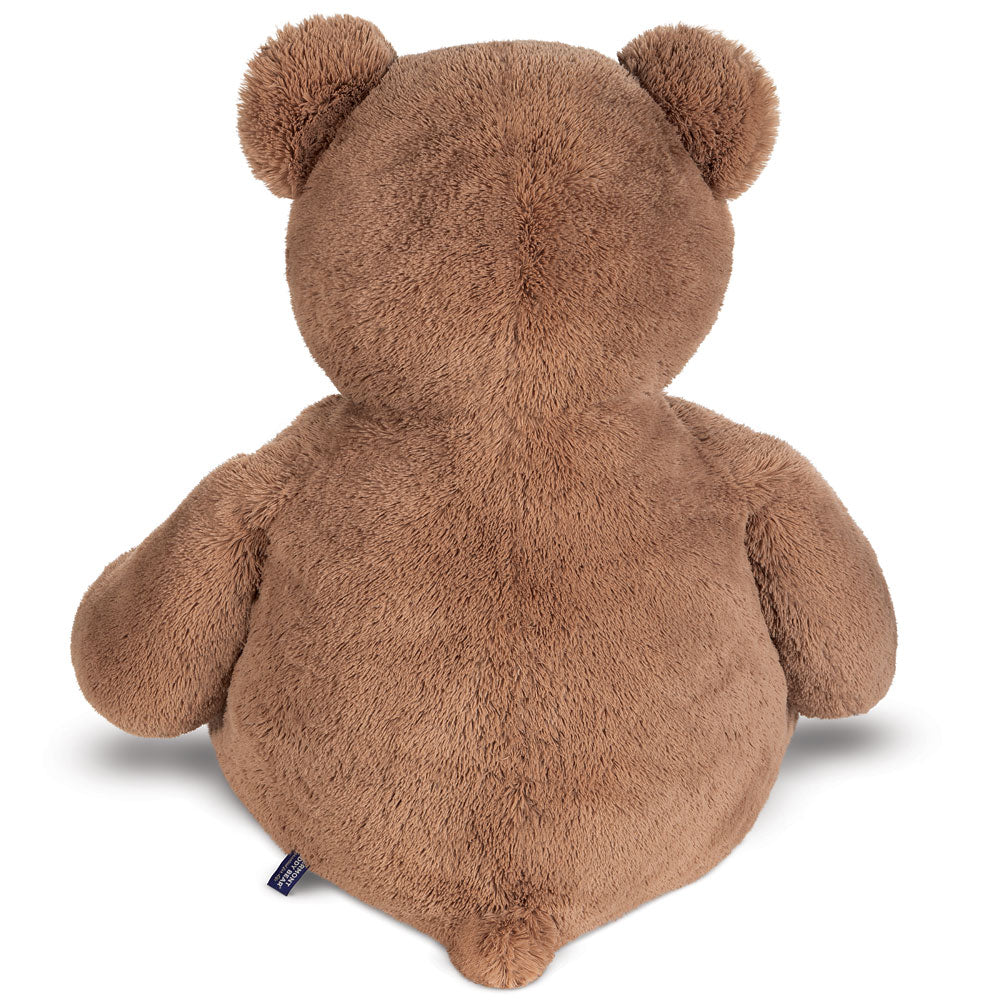 Large plush brown teddy bear viewed from the back with rounded ears and soft fur.